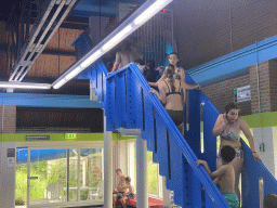 Max on the staircase to the slide at the large pool at the swimming pool at Holiday Park AquaDelta