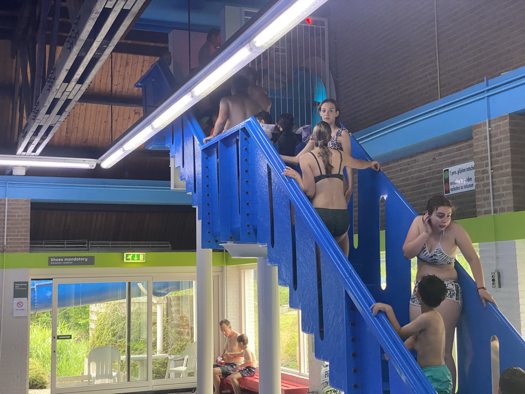 Max on the staircase to the slide at the large pool at the swimming pool at Holiday Park AquaDelta