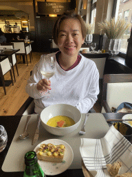 Miaomiao with appetizer and wine at the Brasserie De Cleenne Mossel restaurant