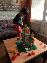 Max playing with Duplo in the living room at the ground floor of our apartment at Holiday Park AquaDelta