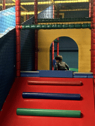 Max playing at the climbing rack at the Kinderland playground at Holiday Park AquaDelta