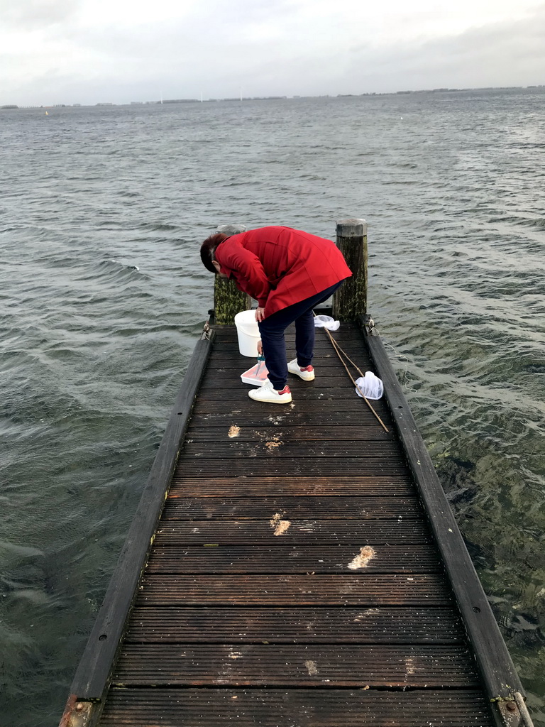 Miaomiao catching crabs on a pier at the northwest side of the Grevelingendam