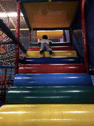 Max playing at the climbing rack at the Kinderland playground at Holiday Park AquaDelta