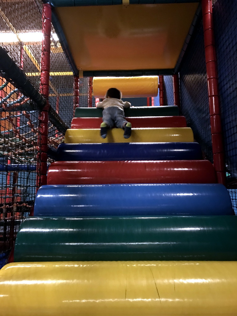 Max playing at the climbing rack at the Kinderland playground at Holiday Park AquaDelta