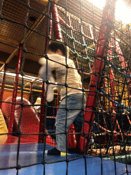 Max playing at the climbing rack at the Kinderland playground at Holiday Park AquaDelta