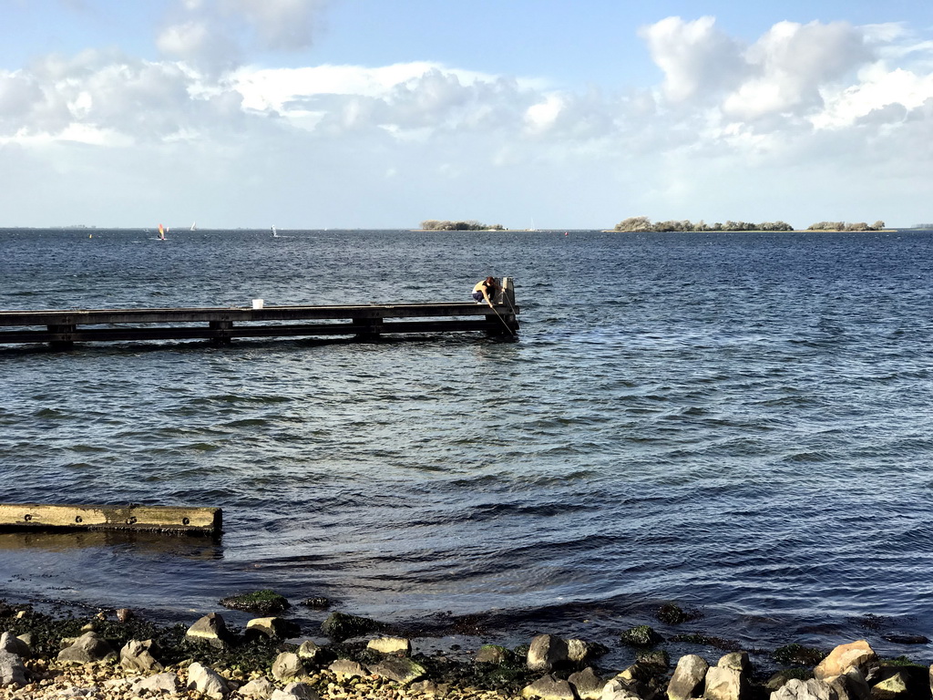 Miaomiao catching crabs on a pier at the northwest side of the Grevelingendam