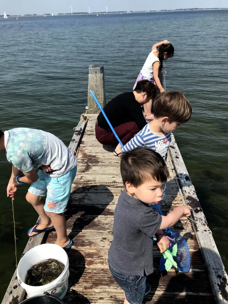 Miaomiao and Max catching crabs on a pier at the northwest side of the Grevelingendam