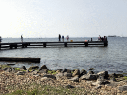 Miaomiao and other people catching crabs on a pier at the northwest side of the Grevelingendam