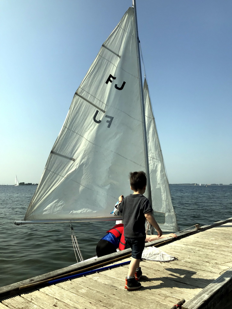 Max on a pier at the northwest side of the Grevelingendam, and and a boat on the Grevelingenmeer lake