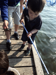 Max and other people catching crabs on a pier at the northwest side of the Grevelingendam