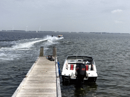 Boats and a water skier on the Grevelingenmeer lake, viewed from a pier at the northwest side of the Grevelingendam