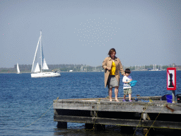 Miaomiao and Max catching crabs on a pier and a boat at the northwest side of the Grevelingendam