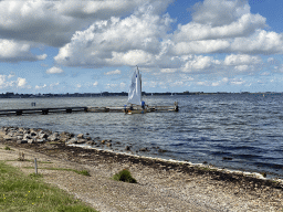 Sailboat at the Grevelingenmeer lake, viewed from the northwest side of the Grevelingendam