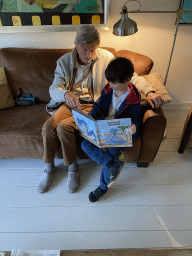 Max and his grandfather looking at Pokémon cards at Max`s grandfather`s home