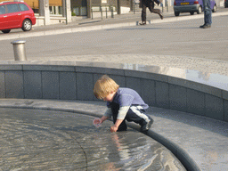 Child playing in a fountain at the Mont des Arts hill