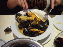 Miaomiao eating mussels in a restaurant in the Rue des Bouchers street