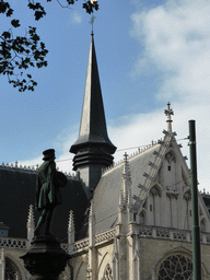 Statue in the Place du Petit Sablon square and the tower of the Église Notre-Dame du Sablon church