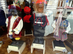 `Manneken Pis` statues in traditional costumes in the window of the GardeRobe MannekenPis museum at the Rue du Chêne street
