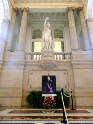 The Grand Staircase and Vestibule of the Royal Palace of Brussels with a statue of Minerva and a photograph of King Baudouin