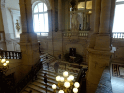 The Grand Staircase of the Royal Palace of Brussels with a statue of Minerva and a photograph of King Baudouin