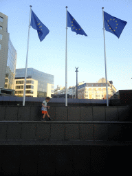 Max in front of European flags at the Schuman Roundabout