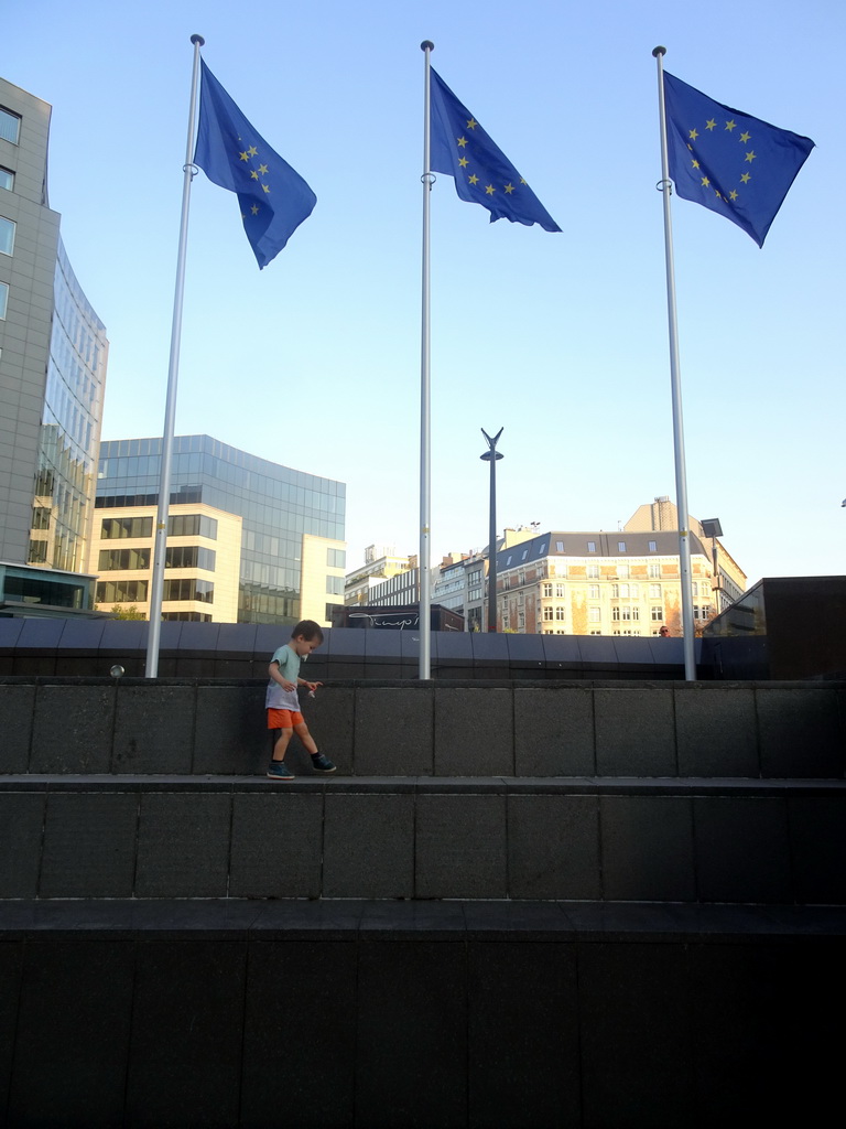Max in front of European flags at the Schuman Roundabout