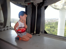 Max at Level 6 of the Atomium, with a view on the Laeken Park