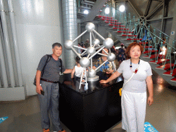 Miaomiao, Max and Miaomiao`s parents with a scale model of the Atomium, at Level 1 of the Atomium