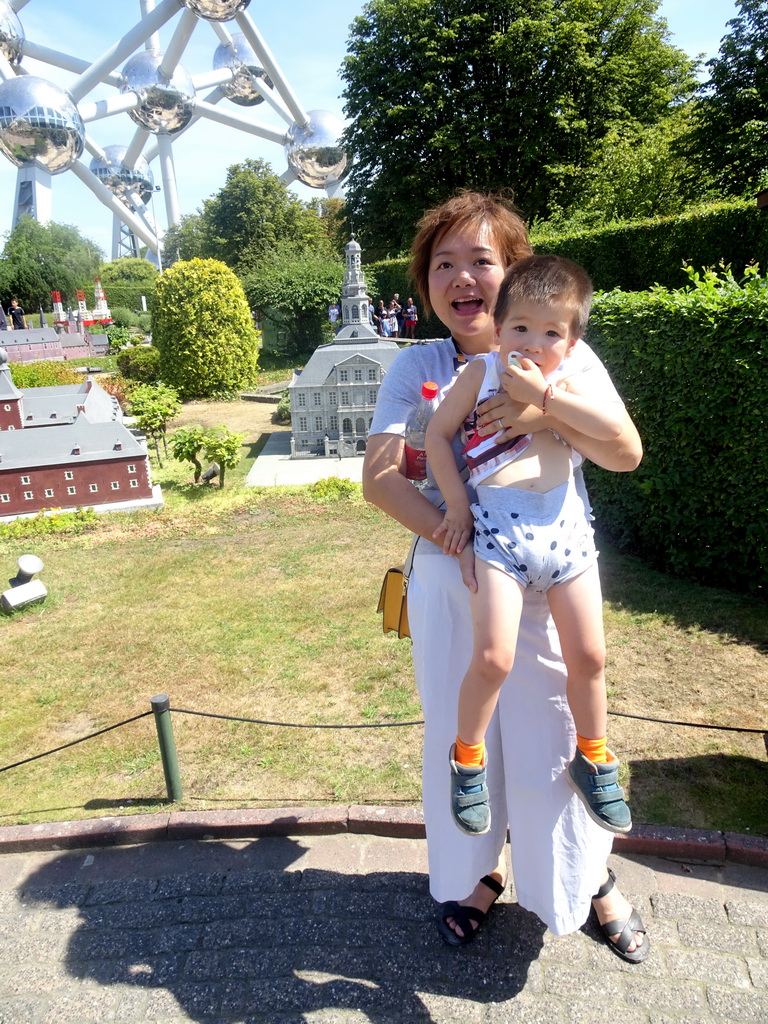 Miaomiao and Max in front of the scale model of the Maastricht City Hall at the Netherlands section of the Mini-Europe miniature park and the Atomium