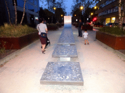 Miaomiao, Max and Miaomiao`s father in front of the Monument for the Victims of the Terrorist Attacks in Brussels of 2016, at the Rue de la Loi street, by night