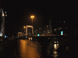 The Elisabeth Bridge (Erzsébet Bridge) over the Danube river, the Inner City Parish Church (Belvarosi Plebaniatemplom) and the Marcius 15. Tér square, by night