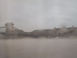 The Széchenyi Chain Bridge and the Gresham Palace in the myst, from the cruise boat on the Danube river