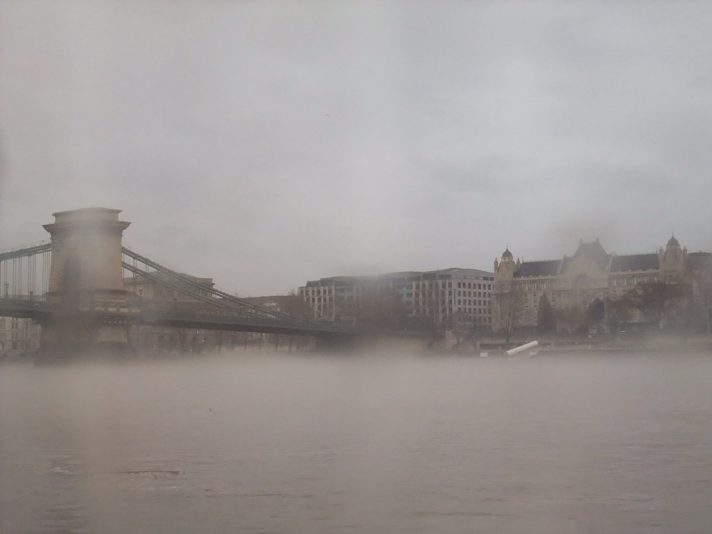 The Széchenyi Chain Bridge and the Gresham Palace in the myst, from the cruise boat on the Danube river