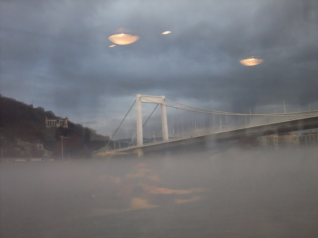 The Elisabeth Bridge and the St. Gellert Monument in the myst, from the cruise boat on the Danube river