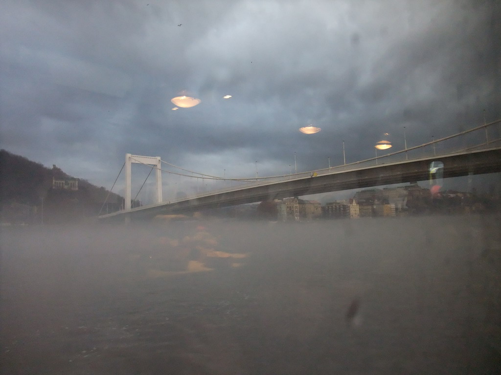 The Elisabeth Bridge and the St. Gellert Monument in the myst, from the cruise boat on the Danube river