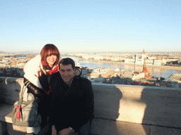 Tim and Miaomiao at the Fisherman`s Bastion, with view on the Hungarian Parliament Building, the Reformed Church of Szilágyi Dezso Tér and the Danube river