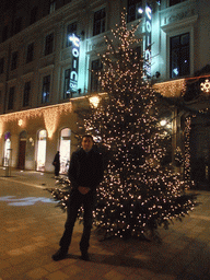 Tim with christmas tree in Dorottya Utca street, by night