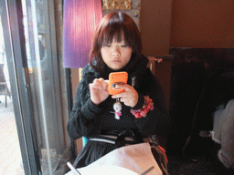 Miaomiao and her iPhone in our lunch restaurant `Cyrano`
