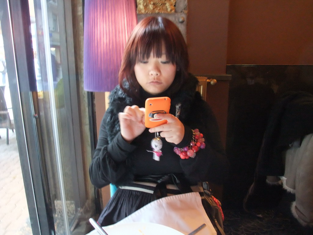 Miaomiao and her iPhone in our lunch restaurant `Cyrano`