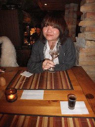 Miaomiao with a glass of Palinka in `Central Cellar Restaurant and Wine Bar`