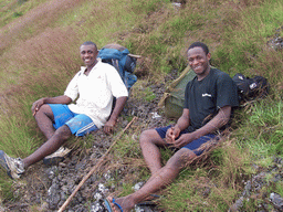 Our tour guides lying in the grass at the slopes of Mount Cameroon