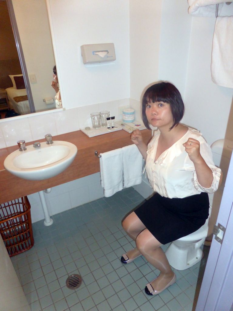 Miaomiao on the toilet in our room in the Coral Tree Inn