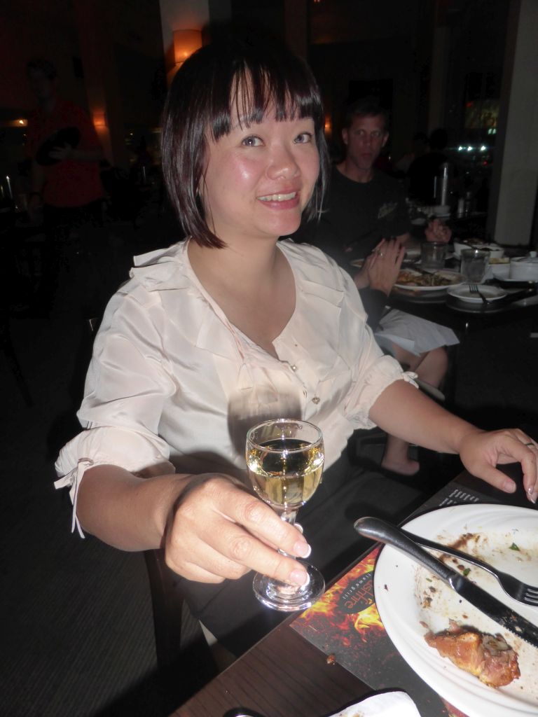 Miaomiao with a glass of wine during the Churrasco Experience dinner at the Bushfire Flame Grill restaurant at the Cairns Esplanade