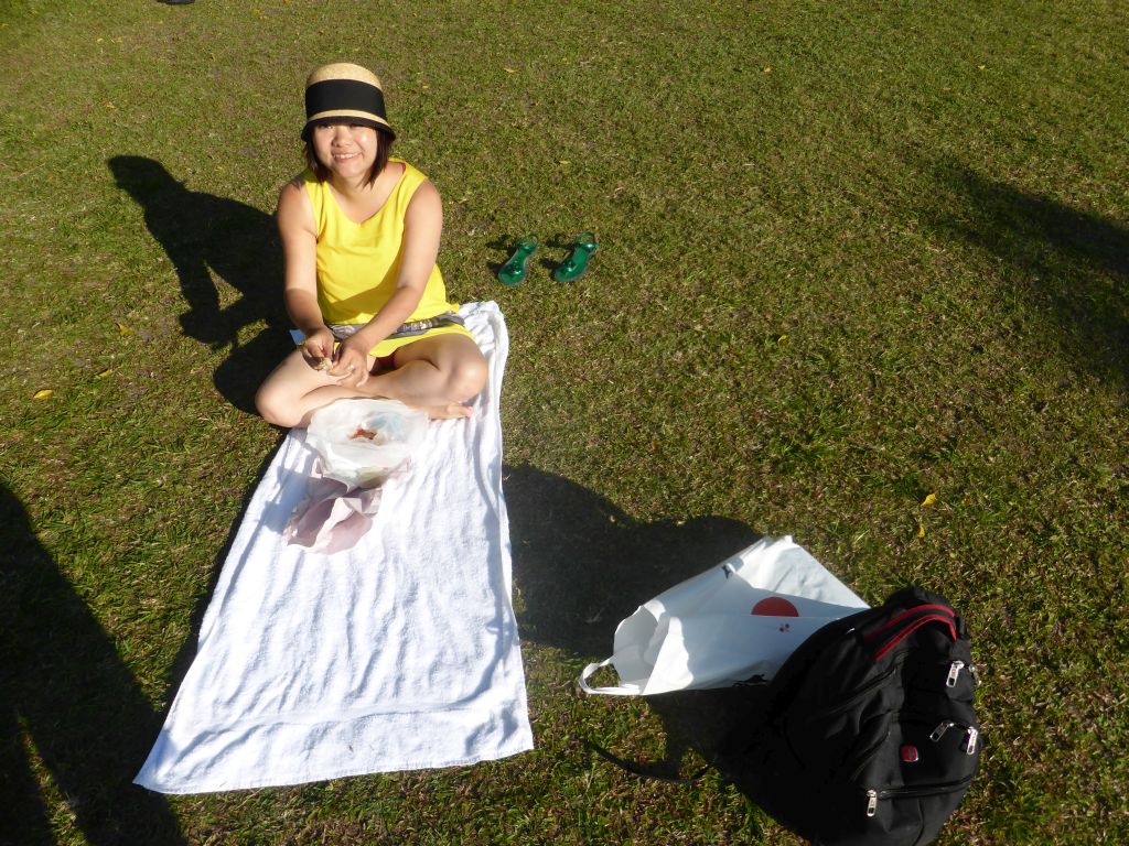 Miaomiao eating shrimps on the grass at the east side of the Cairns Lagoon swimming pool at the Cairns Esplanade