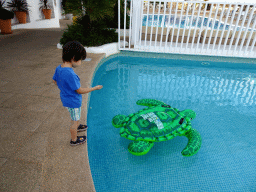 Max with an inflatable turtle at the main swimming pool at the Prinsotel Alba Hotel Apartamentos