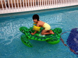 Max on an inflatable turtle at the main swimming pool at the Prinsotel Alba Hotel Apartamentos