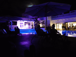 Elvis imitator at the main swimming pool at the Prinsotel Alba Hotel Apartamentos, by night