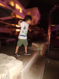 Max dancing at the main swimming pool at the Prinsotel Alba Hotel Apartamentos, by night