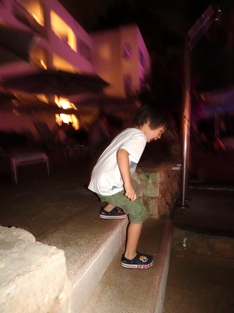 Max dancing at the main swimming pool at the Prinsotel Alba Hotel Apartamentos, by night