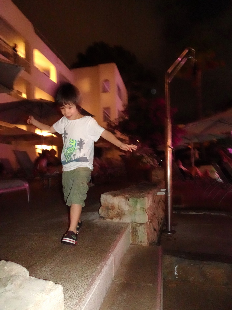 Max dancing at the main swimming pool at the Prinsotel Alba Hotel Apartamentos, by night